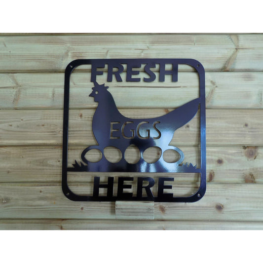 Fresh Eggs Here metal sign with hen sitting on eggs in grass
