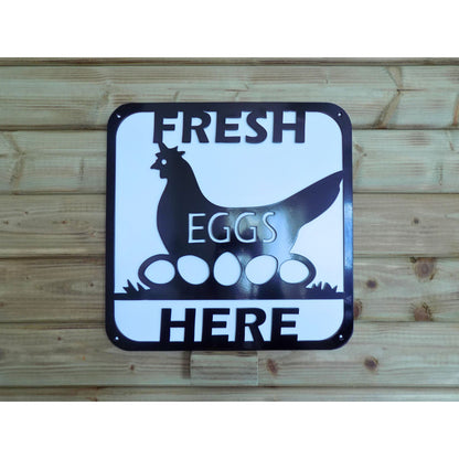 Fresh Eggs Here black metal sign with hen sitting on eggs in grass white backing plate