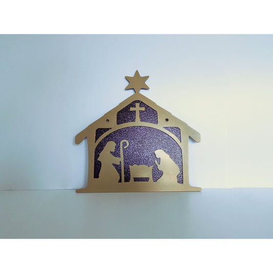 Gold metal nativity wall hanging featuring Joseph, Mary, and baby Jesus in a crib with bronze background.
