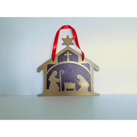 Gold metal nativity wall hanging featuring Joseph, Mary, and baby Jesus in a crib with bronze background and red hanging ribbon.