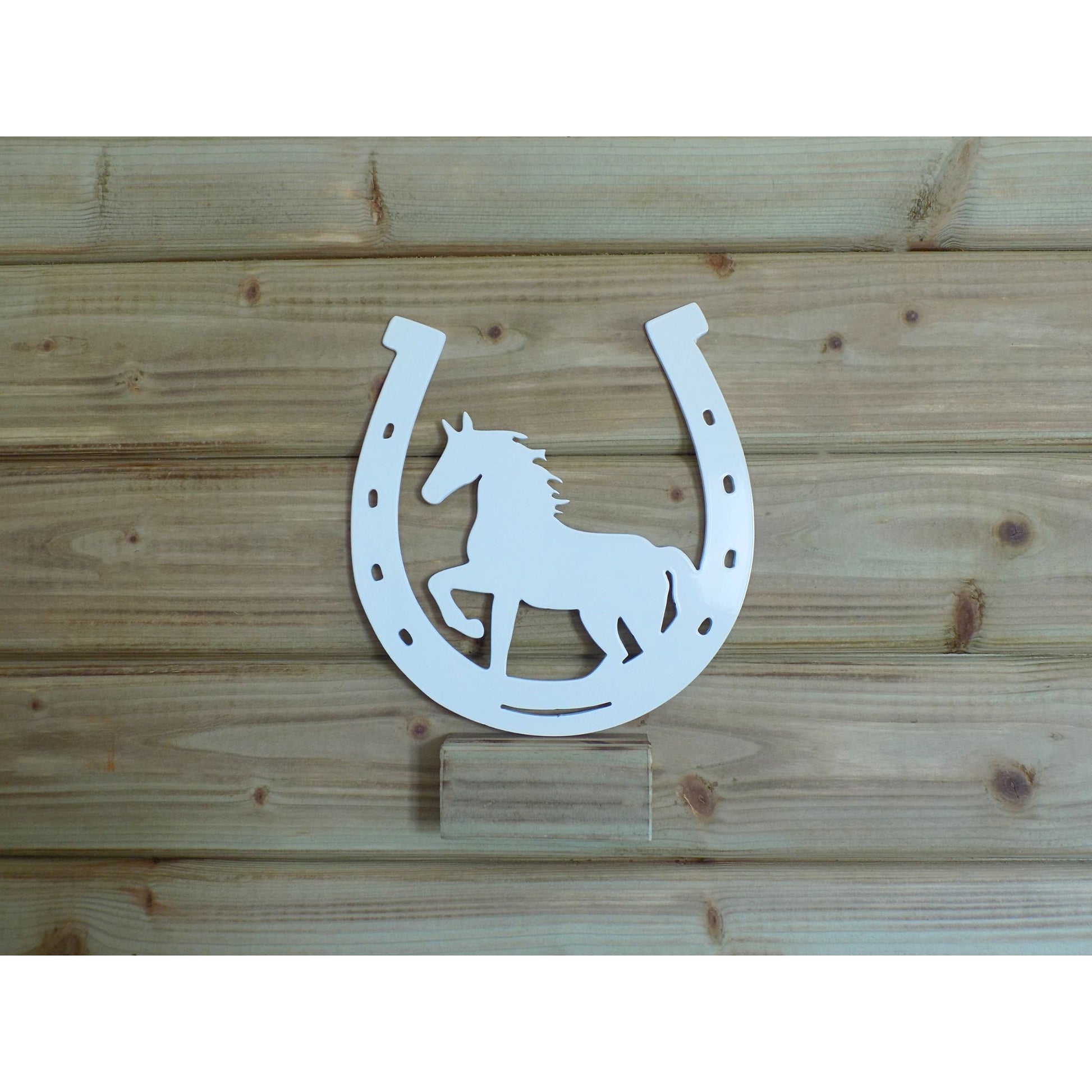 Horseshoe metal sign with trotting horse silhouette, white powder-coated finish, handcrafted in Ireland