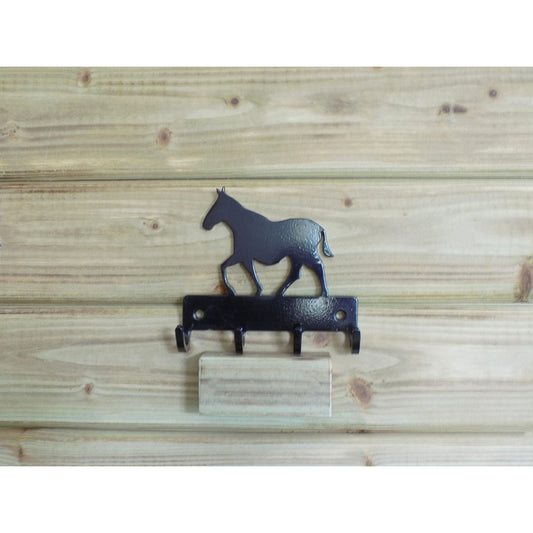 black metal horse wall key holder with hooks on wooden background