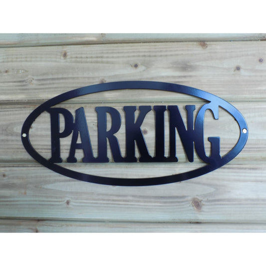 Black oval metal sign with cutout text “PARKING”, wall-mounted and powder-coated. Handmade in Ireland for gates, driveways, or private property
