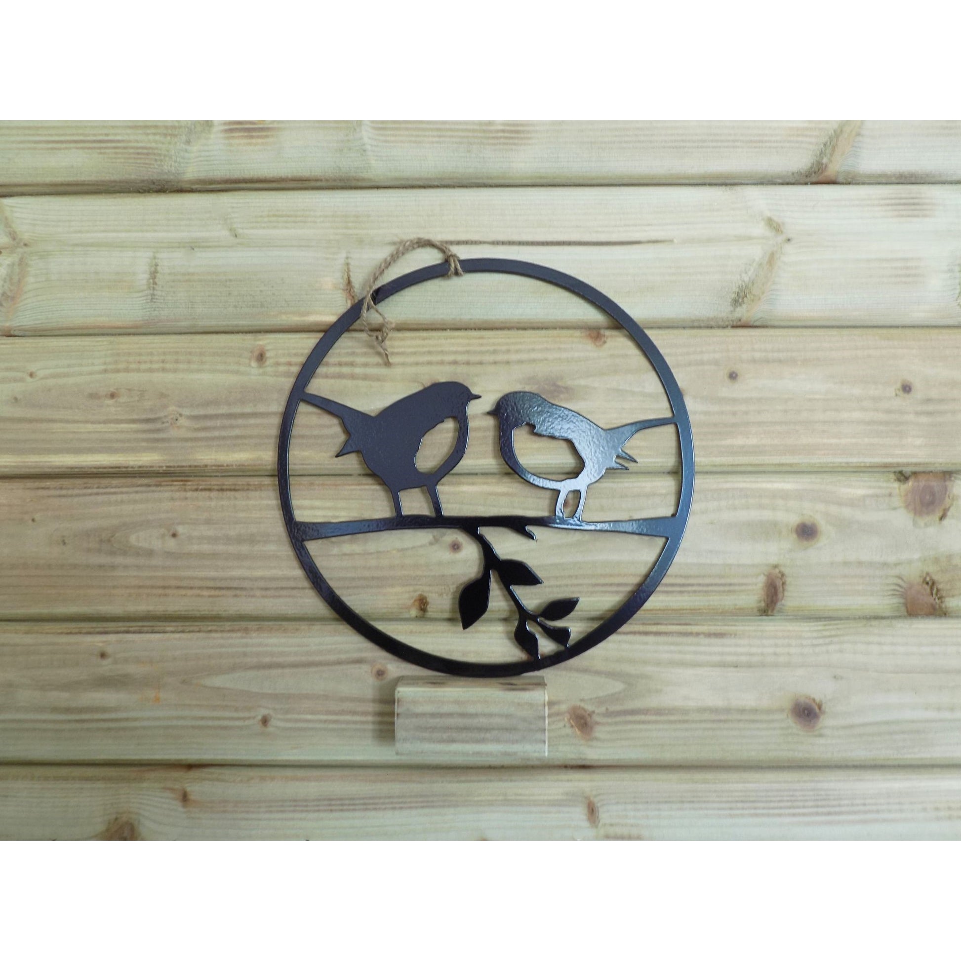Round metal robin wall art with two robins on a branch, handmade in Ireland, available in black finish