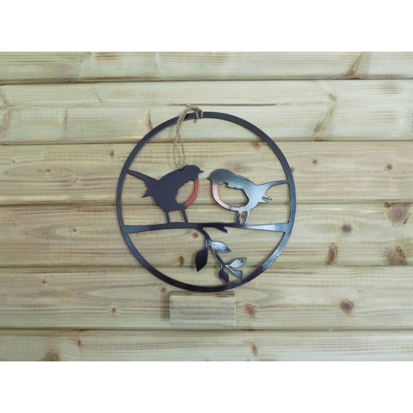 Round metal robin wall art with two robins on a branch, handmade in Ireland, available in red/black finish