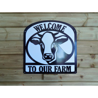Welcome to Our Farm sign with dairy cow silhouette in black steel and white backing plate