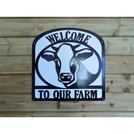 Welcome to Our Farm sign with dairy cow silhouette in black steel and white backing plate